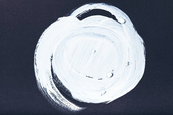 abstract painting with white round brush strokes on black