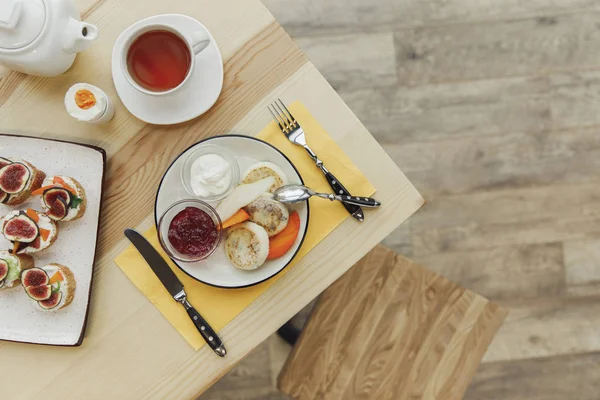 Top view of tasty healthy breakfast with tea set on wooden table — Stock Photo