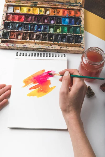 Tiro recortado de artista segurando pincel de pintura e desenho pintura abstrata — Fotografia de Stock