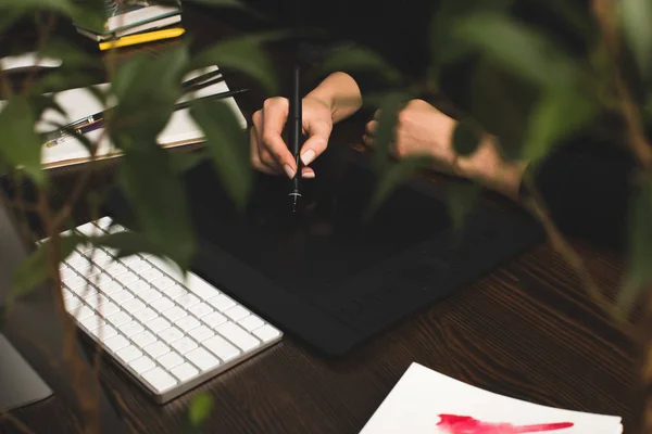 Ritagliato colpo di progettista utilizzando tablet grafica sul posto di lavoro — Foto stock