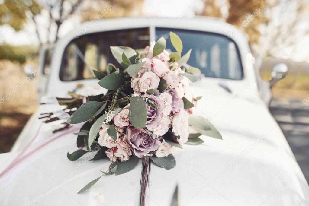 Wedding bouquet lies on the car. Wedding day. Summer Day