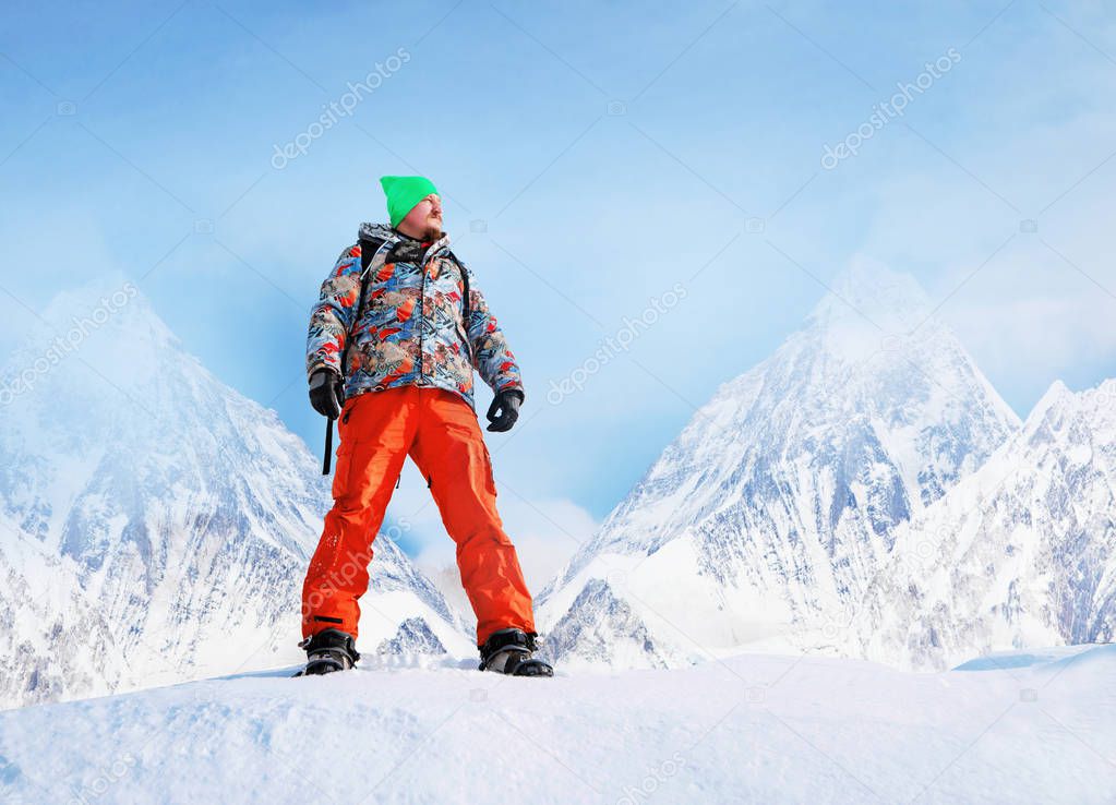 Young man snowboarding in the mountains