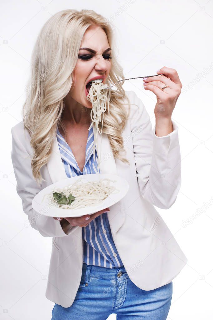 Beautiful young woman eating Italian pasta.