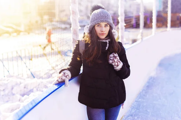 Pretty young woman at ice-skating rink.