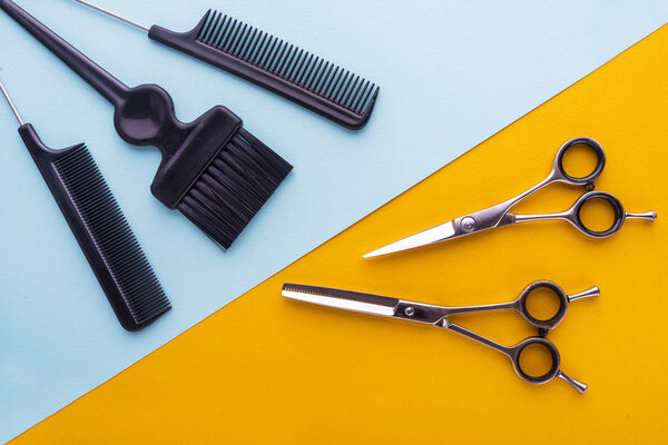 Professional hairdresser tools on colored background