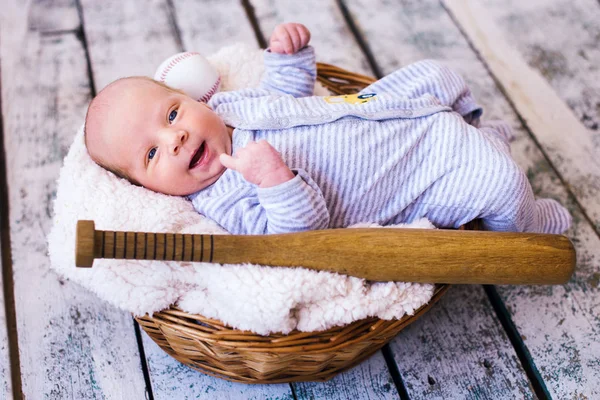 Newborn baby boy with baseball bat and ball. Future champion — Stock Photo, Image