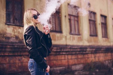 Vaping. Genç güzel kadın vaping. Buharı kavramı.