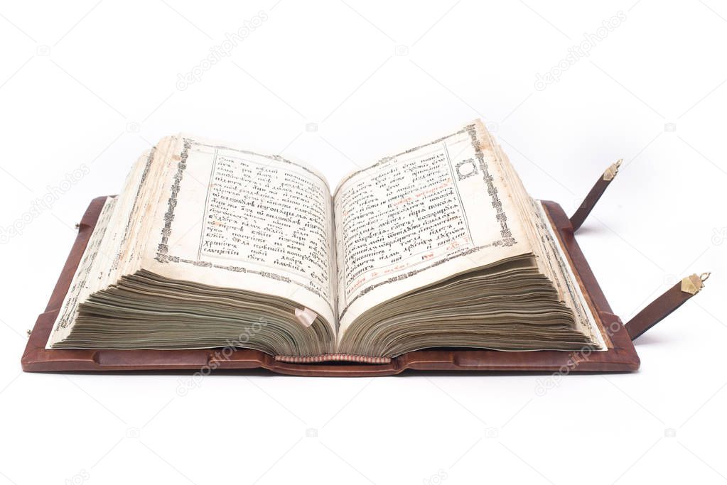 Old open antique bible isolated on white background with clipping path.