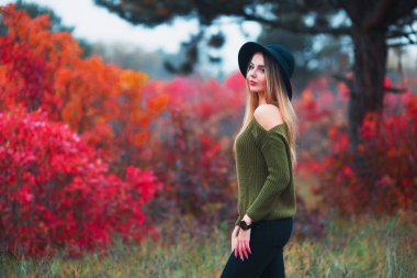 Siyah şapka ve yeşil kazak genç çekici kız. Genç kadın çıplak omuz ile