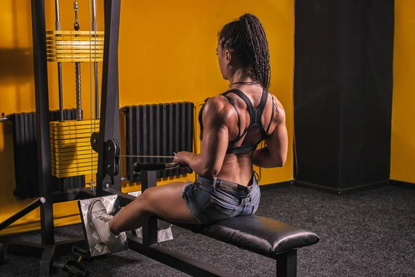 Joven fitness mujer ejecutar ejercicio con máquina de ejercicio Cable Crossover en el gimnasio, foto horizontal —  Fotos de Stock