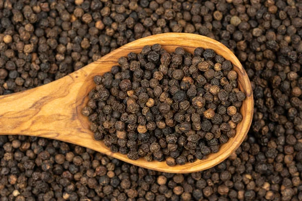 Spice Background Background Made Many Whole Black Peppercorns Cooking Spoon — стоковое фото