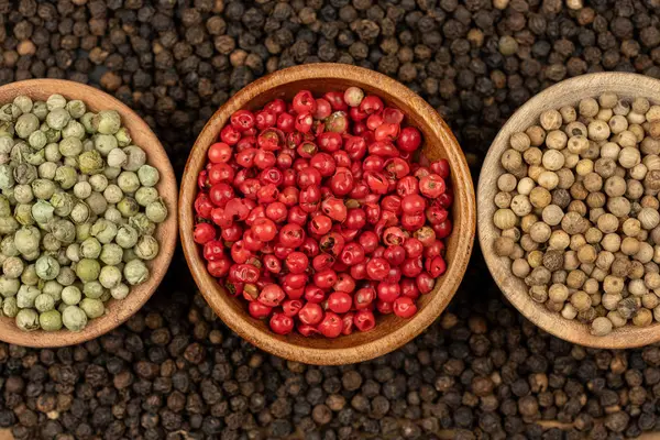 Spice Background Background Made Many Whole Black Peppercorns Three Wooden — стоковое фото