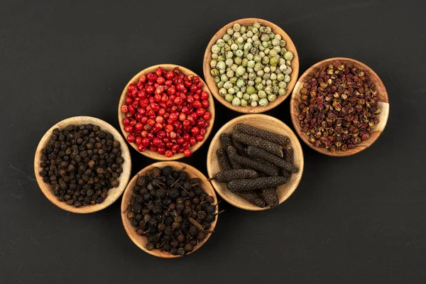 Six Small Wooden Bowls Filled Various Peppercorns Black Background — Stock Photo, Image