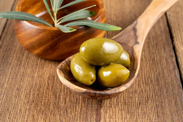 Green Olives Wooden Cooking Spoon Olive Branch Wooden Bowl Background — Stock Photo, Image