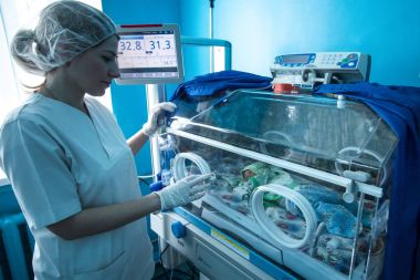 Obstetrician and premature infant in intensive care unit in the maternity hospital in Kramatorsk, Donetsk region, Ukraine clipart