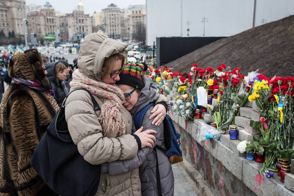 KIEV, UKRAINE - Feb 20, 2016: People attend a commemoration ceremony at monument to so-called "Heavenly Hundred", people killed during Ukrainian pro-European mass protests in 2014 in Kiev, Ukraine.