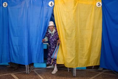 An old woman votes at a polling station during local elections in Chernihiv, Ukraine clipart