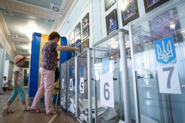 A woman votes at a polling station during local elections in Chernihiv, Ukraine clipart