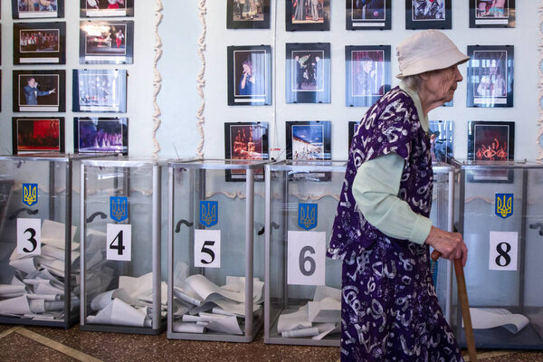 An old woman votes at a polling station during local elections in Chernihiv, Ukraine