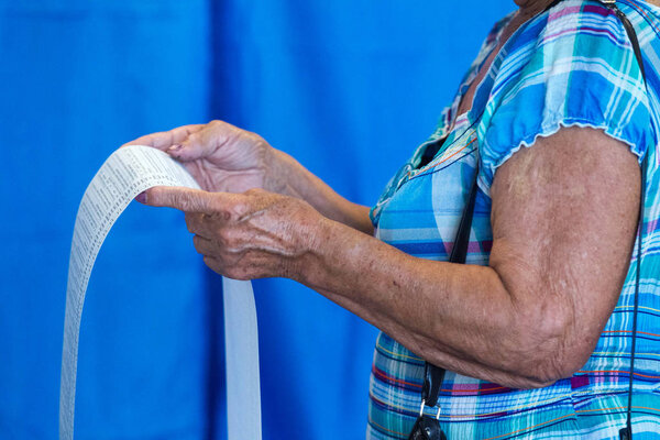 An old woman votes at a polling station during local elections in Chernihiv, Ukraine