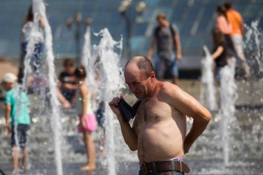 İnsanlar çeşme bağımsızlık Meydanı Kiev, Ukrayna sıcak bir günde üzerinde soğutma