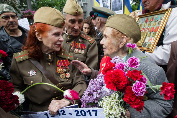People take part in the Immortal Regiment memorial demonstration with portraits of their relatives, who participated in World War II, in central Kiev, Ukraine