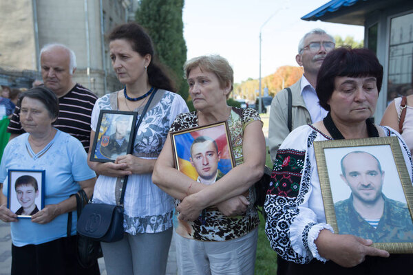 Relatives hold portraits of servicemen, killed in conflict in eastern Ukraine as they attend a rally in front of the Russian embassy in Kyiv, Ukraine. August 28, 2019.