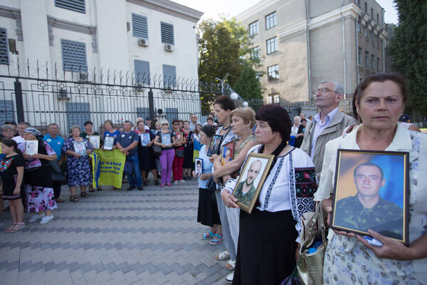 Relatives hold portraits of servicemen, killed in conflict in eastern Ukraine as they attend a rally in front of the Russian embassy in Kyiv, Ukraine. August 28, 2019.