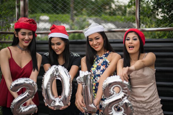 Young people holding glass talk in the party.