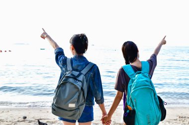 Güzel kız sahilde mutlulukla yürüyor.