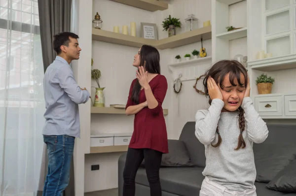 stock image Little girl is crying because her parents quarrel.