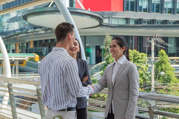 Young businessmen meeting outside the business district.