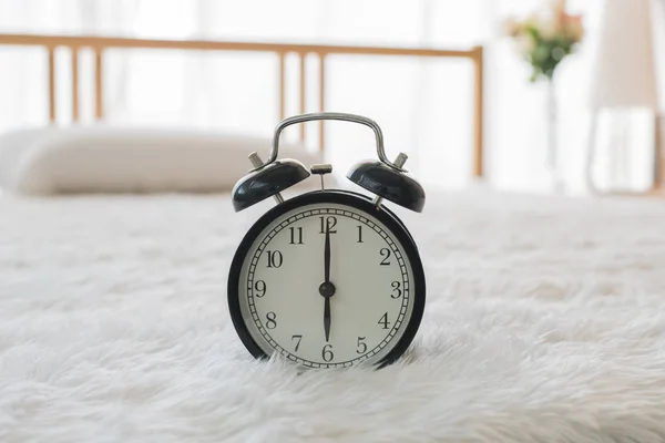 The black alarm clock rings  in the morning in the home. — Stock Photo, Image