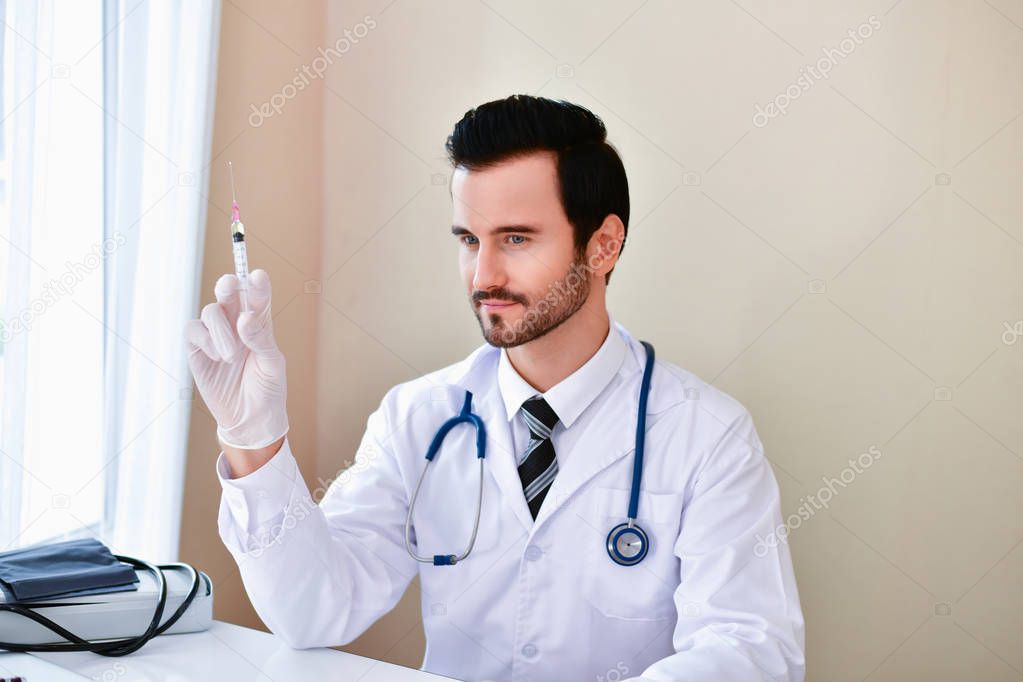 Smiling doctor posing in the office, he is wearing a stethoscope