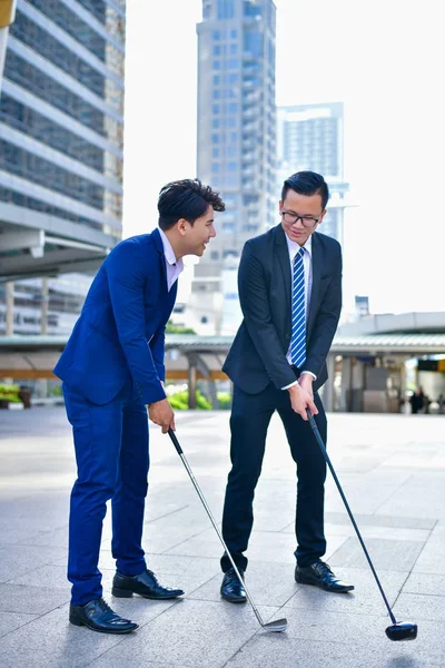 Concept Business people playing sports, Businessmen play golf to