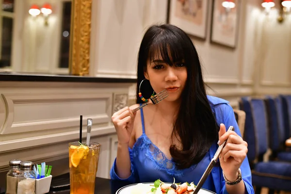 Restaurant Concept. Asian women eating in restaurant. Asian wome