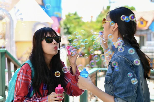 Travel Concepts. Beautiful girl is playing soap bubble fun. Asia