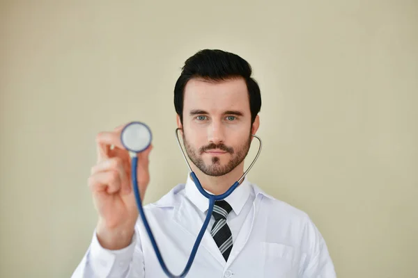 Smiling doctor posing in the office, he is wearing a stethoscope Stock Image
