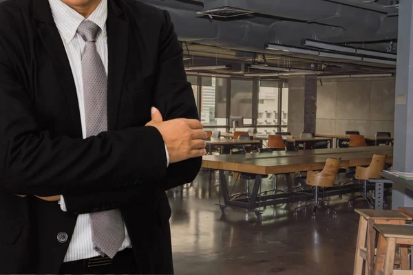 Male model in a suit posing on office background