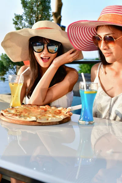 Travel Concepts. Beautiful girl is eating at a seaside restauran