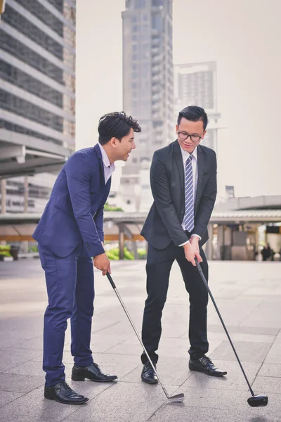 Concept Business people playing sports, Businessmen play golf to