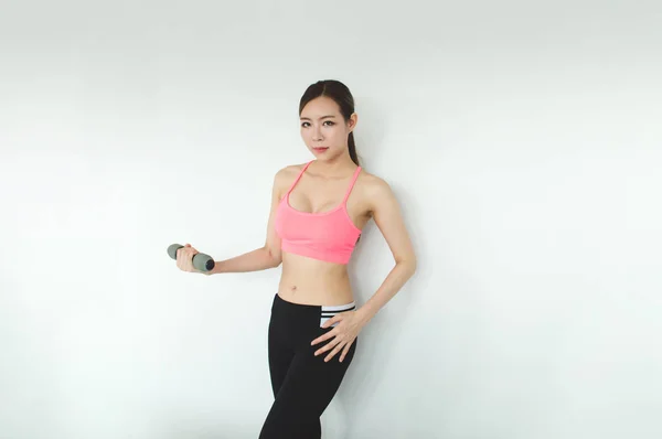 Sports concept. Beautiful girl is exercising in the home with wa — Stock Photo, Image