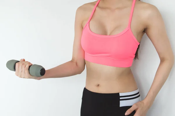 Sports concept. Beautiful girl is exercising in the home with wa — Stock Photo, Image