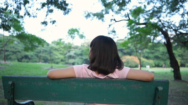 Holiday concept. The girl sitting back Look at the nature in the