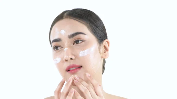Beauty concept. Beautiful girl is happily applying cream on her — 스톡 사진