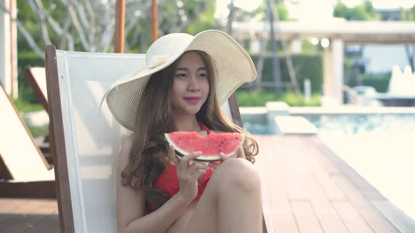 Holiday concept. A girl eating watermelon by the pool. 4k Resolu — 스톡 사진
