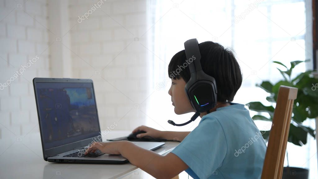 Family concept. The boy is playing computer games at home. 4k Re