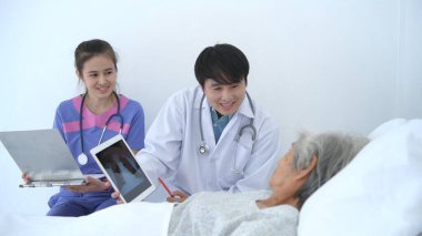 Tıbbi kavramlar. Doktor hastanede bir tablet kullanarak tedaviyi hastaya tanımladı. 4k Çözünürlüğü.