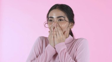 Beauty concept. Beautiful Asian girl opens her eyes with surprise on the pink background. 4k Resolution. clipart