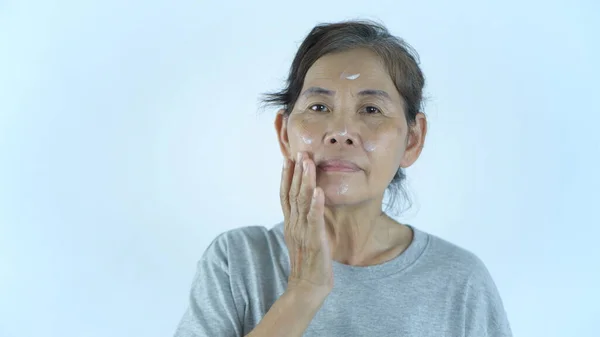 Beauty Concept Old Woman Applying Cream White Background Resolution — Stock Photo, Image